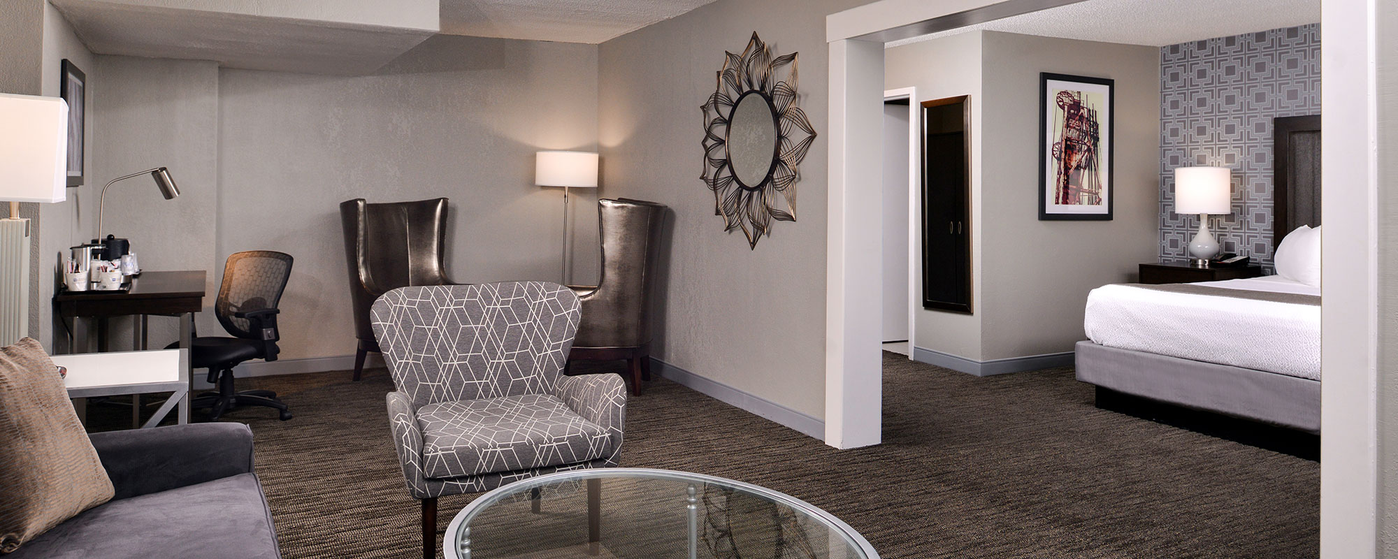 suite with one king bed and living area